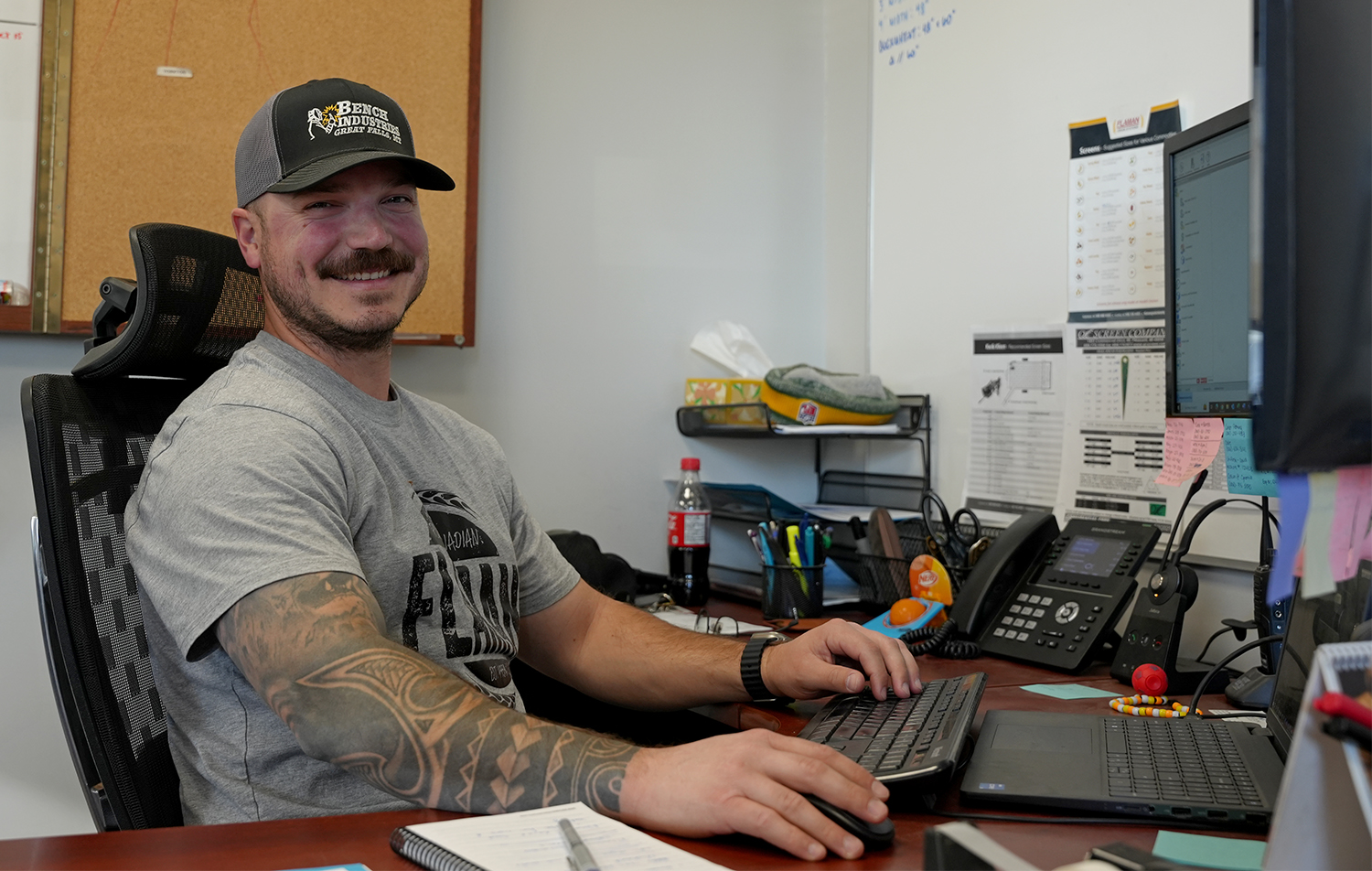 Photo of man stting at computer